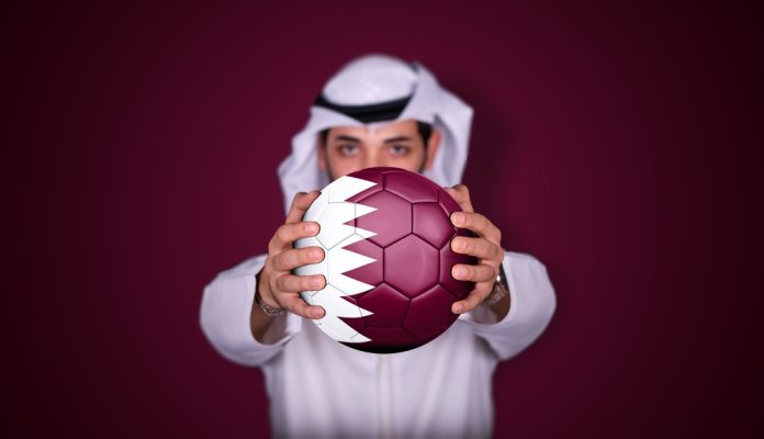 Arab,Man,Holding,Soccer,Ball,In,Hand,With,Qatar,Flag