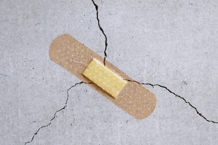 A,Bandage,Is,Stuck,To,A,Crack,In,The,Concrete