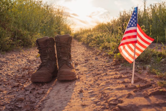 Military,Boots,With,The,United,States,Flag,In,The,Field